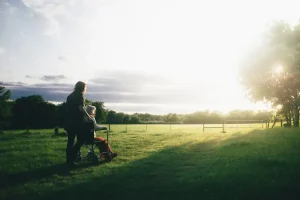Woman being pushed in wheelchair to show world hospice day.