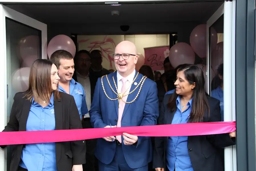 Local mayor cutting a ribbon to open Blossom's first shop front office in Grimsby.