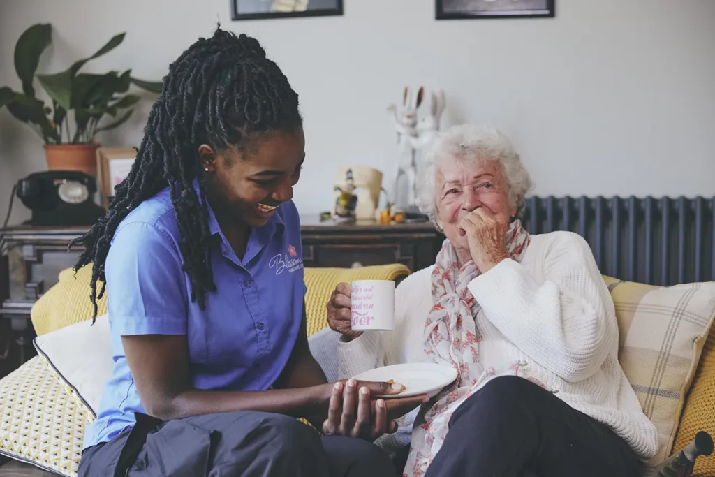 blossom home care client laughing with carer