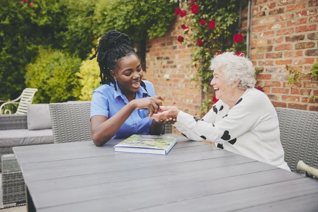 blossom home care carer applying suncream to client
