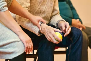 Blossom Home Care Carer Helping Man With Rehabilitation Excersises Post Stroke.