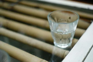 A glass of clear water on a table.
