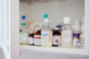 Medicine bottles lined up on a shelf.
