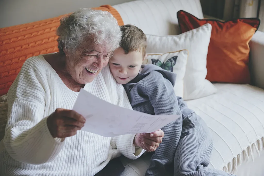 Elderly client spending quality time with her grandson, supported by companionship care.